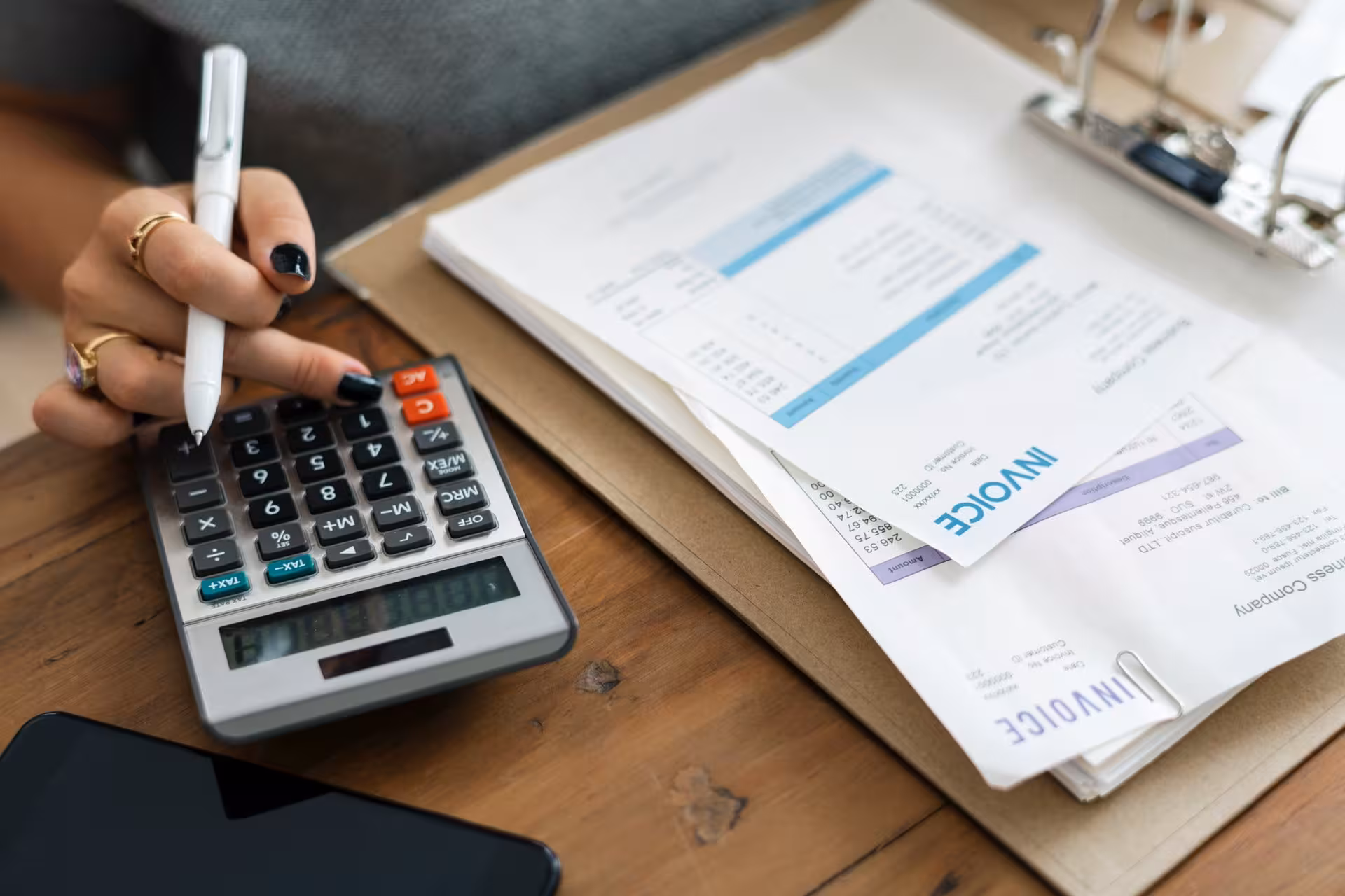 Women doing calculations on a calculator 