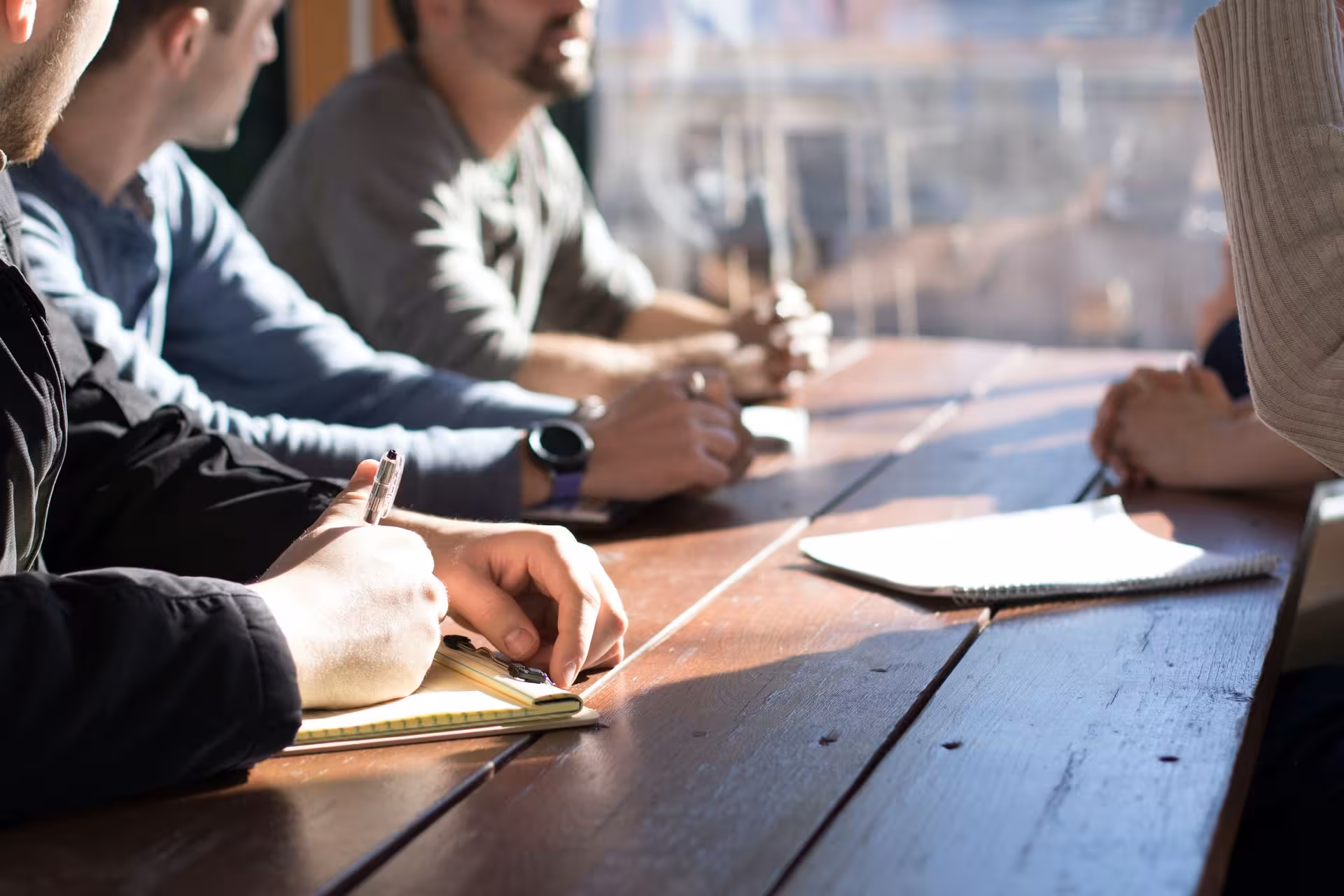 Meeting at a table with multiple males