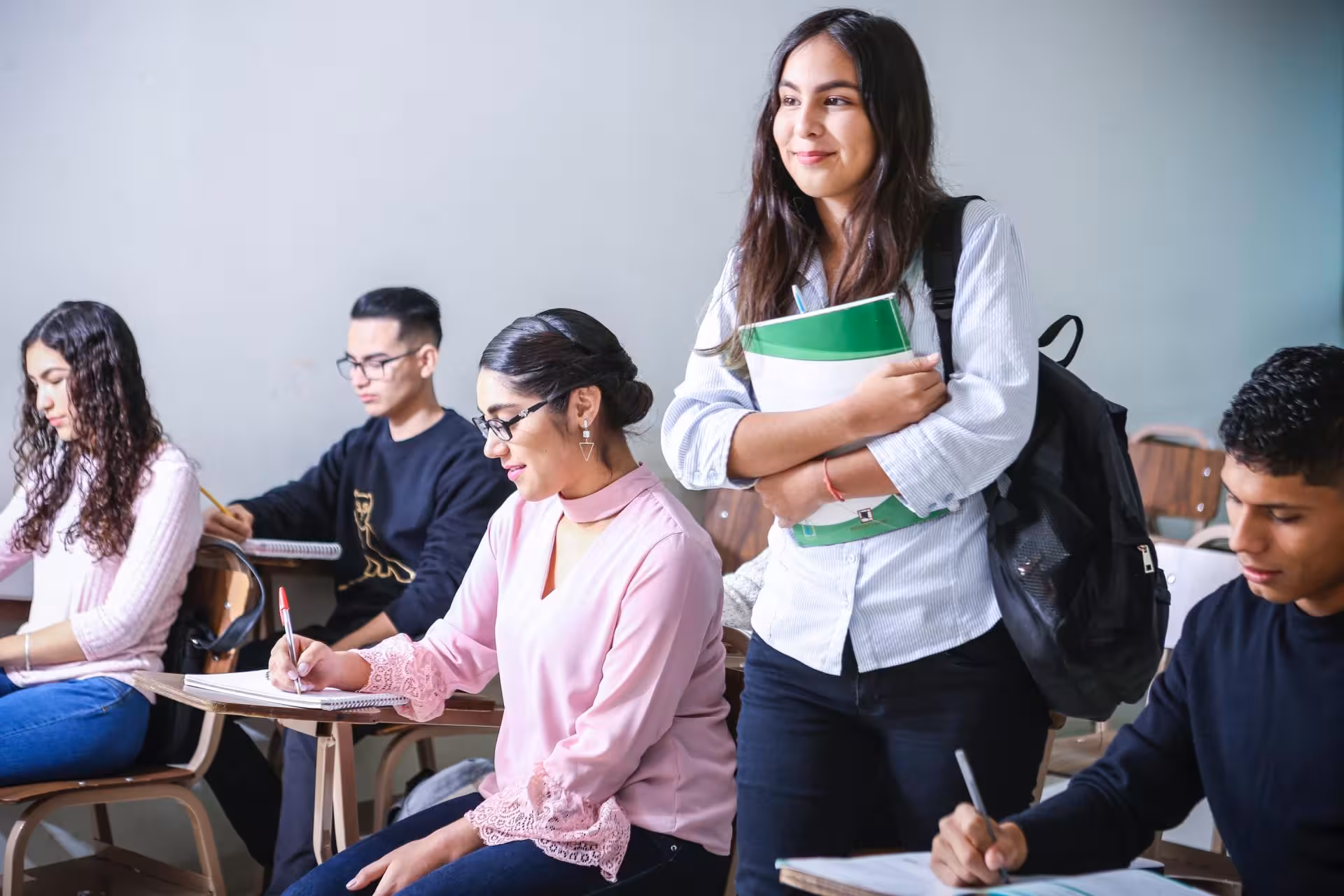 Students in a classroom taking notes